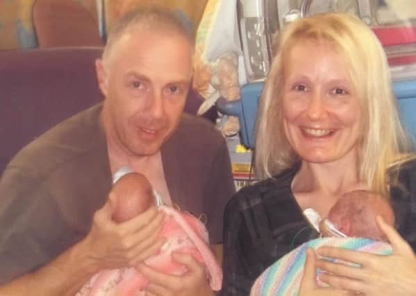 Joanne Gray and partner Darren, with their babies, who were three months old