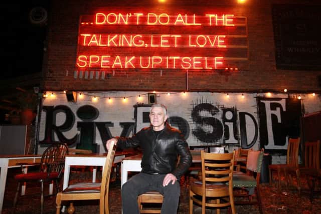 The Riverside pub in Sheffield has put up a new neon sign outside with a quote from a Housemartins song. The sign was bought by a man to propose to his girlfriend who broke up with him when she saw the sign. So now the pub's owner True North Brewery has bought it. MD of True North Kane Yeardley is pictured with the sign. Photo: Chris Etchells