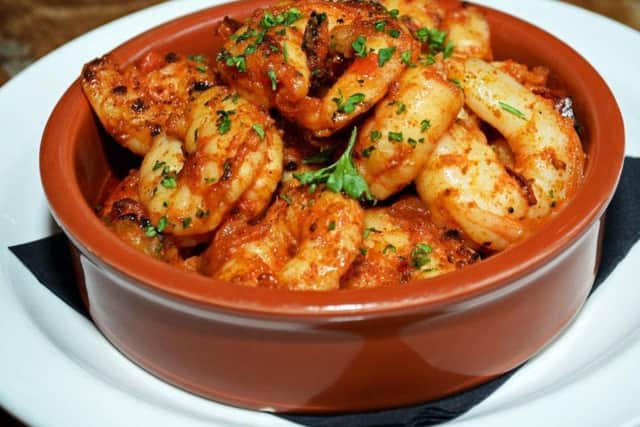 Gambas Pil Pil. Pan fried Tiger Prawns, deveined and cooked in Garlic and Olive Oil, with sliced Roast Peppers and a touch of Chilli. Picture: Marie Caley