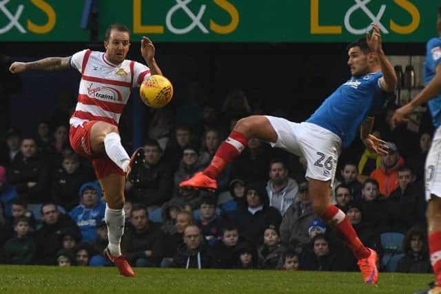 Doncaster's James Coppinger battles with Portsmouth's Gareth Evans