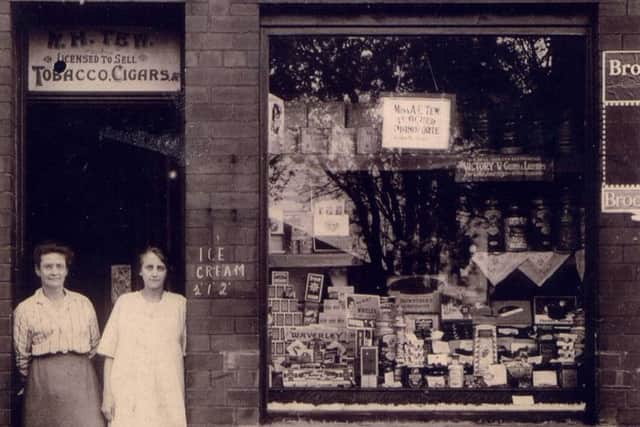 Flory with her daughter Evelyn outside her shop at Providence Road, Walkley.