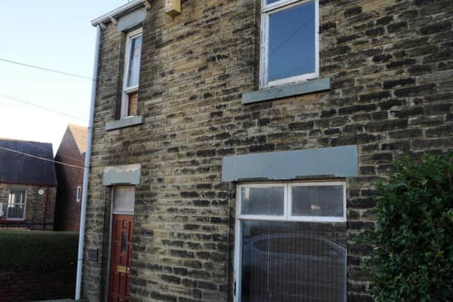 One of the front windows is boarded up at the house on Mulehouse Road, in Crookes