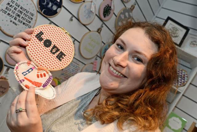 Ellie Mason, of Fuzzy Pigg, pictured with some of her quirky ValentineÃ¢Â¬"s cards, embroidered homewares and accessories at this years Pop-up Valentines shop in the Winter Gardens. Picture: Marie Caley NSST Valentines Pop-up MC 5