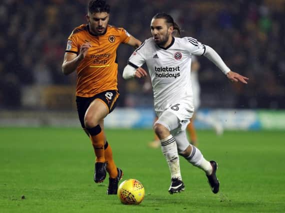 Ricky Holmes runs clear of Ruben Neves