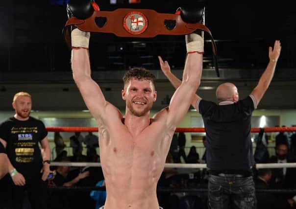 Lee Appleyard celebrates with the English lightweight title. Picture: Dean Woolley