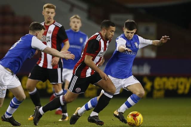 Samir Carruthers of Sheffield United in action against Connor Kirby of Sheffield Wednesday: Simon Bellis/Sportimage