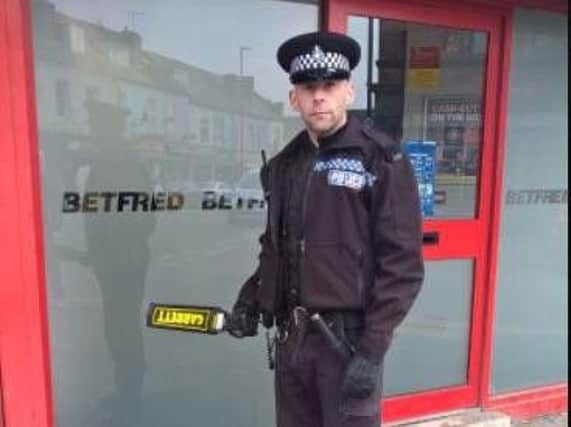 A PCSO with a metal detector in Darnall today in a crackdown on knife crime