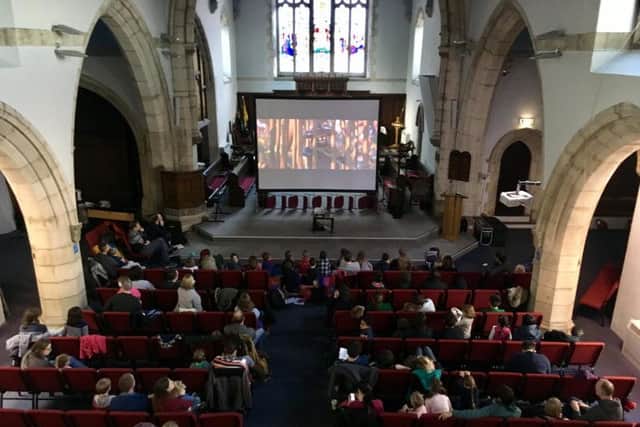 Families gather at St Timothy's Church for the community cinema.