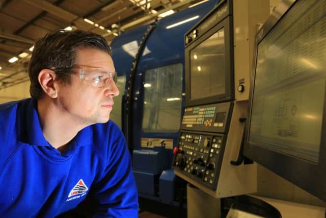 Andrew Hll with a new Â£1.1m 11-axis machine tool at AESSEAL. Pic: Chris Etchells.