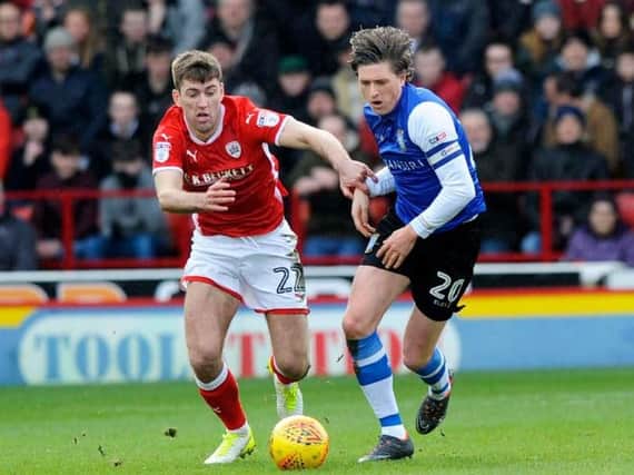 Sheffield Wednesday's Adam Reach finds himself under pressure from Barnsley's Gary Gardner in the 1-1 draw at Oakwell