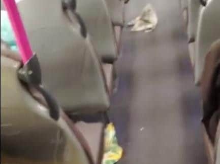 Litter in the aisles of the bus.