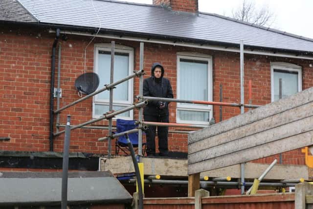 Tina on her neighbour's flat roof. Picture: Chris Etchells/The Star