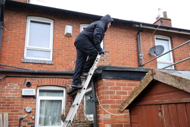 Tina used a ladder to scale the structure which adjoins her property. Picture: Chris Etchells/The Star
