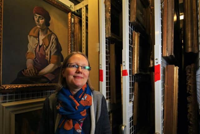 Sian Brown with paintings in Museums Sheffield's store. Picture: Chris Etchells