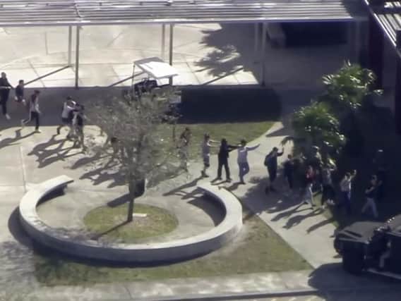 Screen grab by WPLG-TV  showing students from the Marjory Stoneman Douglas High School in Parkland, Florida, evacuate the school following a shooting.