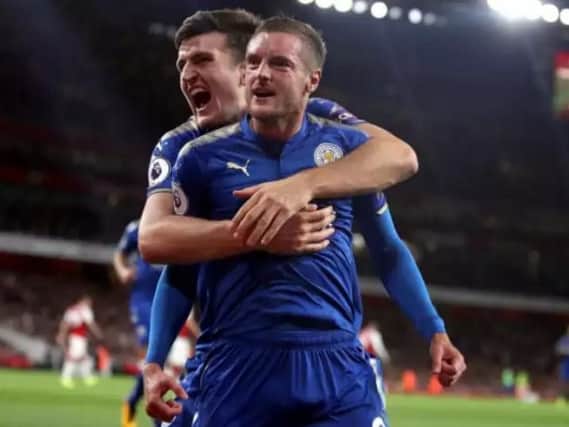 Harry Maguire celebrates with Leicester teammate Jamie Vardy