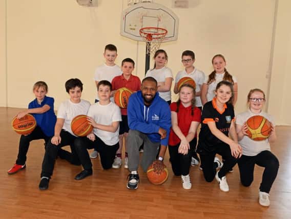 Chris Alexander, Sheffield Sharks player, pictured with year six children from Fox Hill Primary school, during a B.Healthy B.Braun session at the school. Picture: Marie Caley