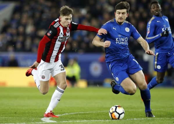 Sheffield United's David Brooks (left) and Leicester City's Harry Maguire battle for the ball during the Emirates FA Cup, Fifth Round match at the King Power Stadium, Leicester. PRESS ASSOCIATION Photo.