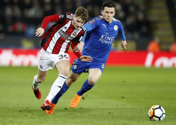 Sheffield United's David Brooks (left) and Leicester City's Ben Chillwell battle for the ball during the Emirates FA Cup, Fifth Round match at the King Power Stadium.