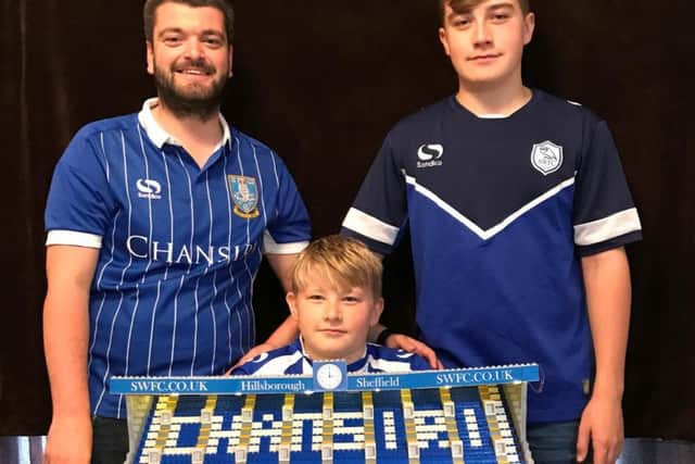 Jordan Sykes (left), Harry Carr (middle) and Jack pictured with the north stand of Lego Hillsborough, which they built first.