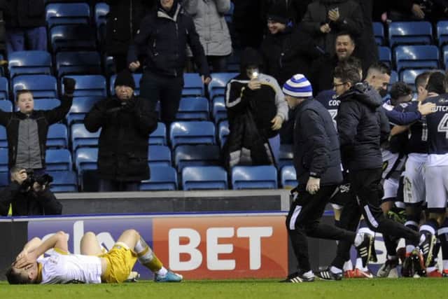 Jordan Thorniley lies down injured after a collision in the build-up to Millwall's second goal