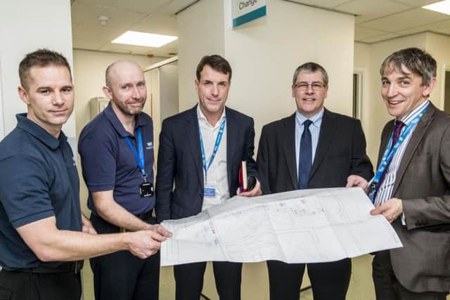 Graham Royle looks over the plans for the new MRI scanner at Sheffield Children's Hospital with Chris Heafeyand Mark Haines from the radiology department, Chief executive John Somers and charity director David Vernon-Edwards