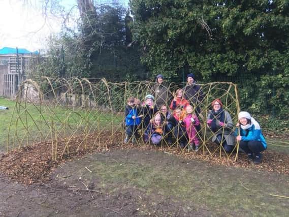Volunteers with their newly-created willow tunnel at Woodseats Playground