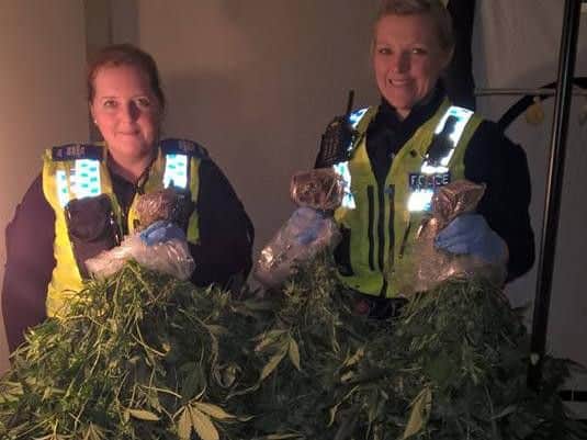 Officers with the cannabis they discovered.