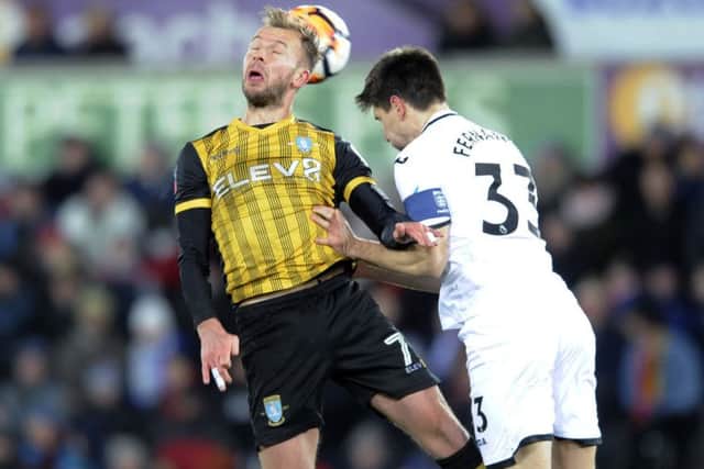 Owls Jordan Rhodes with Swans Federico Fernandez.....Pic Steve Ellis