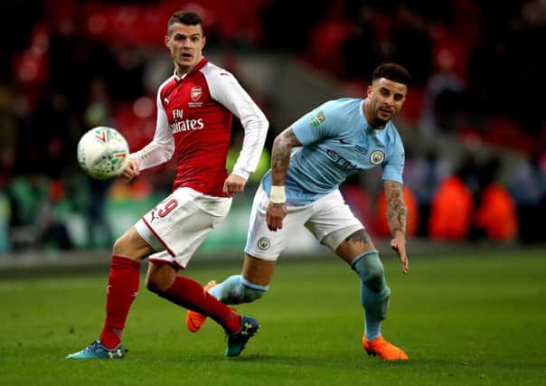 Arsenal's Granit Xhaka (left) and Manchester City's Kyle Walker (right) battle for the ball - it's all about Premier League teams, these days.