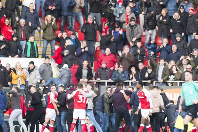 Rotherham players are swamped by fans after securing victory. Picture: Dean Atkins.
