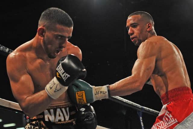 Tyan Booth (right) fighting Rotherham's Nav Mansouri.