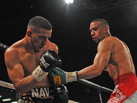Tyan Booth (right) fighting Rotherham's Nav Mansouri.