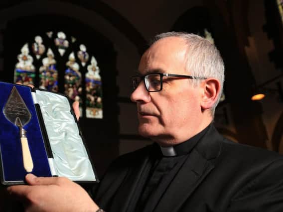 The Reverend Canon Keith Farrow with the trowel he bought at auction. Picture: Chris Etchells