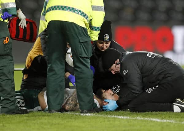 Barnsley's Adam Jackson is treated on the pitch during the Sky Bet Championship match at the KCOM Stadium, Hull. PRESS ASSOCIATION Photo.