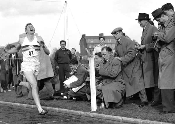Britain's Roger Bannister hits the tape to become the first person to break the four-minute mile