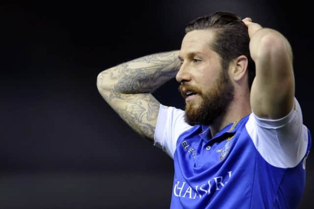 Jacob Butterfield with his head in his hands after the final whistle in the defeat to Ipswich Town