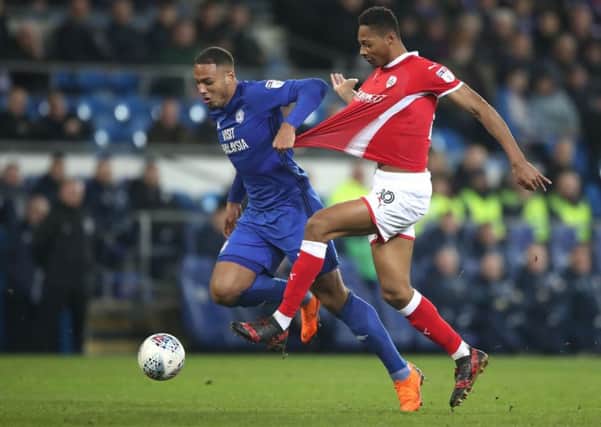 Cardiff City's Kenneth Zohore (left) battles with Barnsley's Mamadou Thiam during the Sky Bet Championship match at Cardiff City Stadium. Pic: Nick Potts/PA Wire.