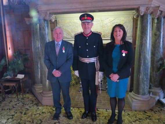 Martin Windle and Teresa Smith with the Her Majesty's Lord-Lieutenant for South Yorkshire Andrew Coombe after receiving their British Empire Medals