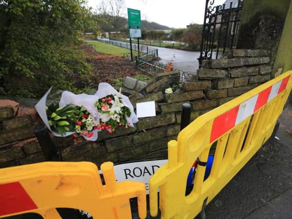 Tributes and flowers have been left at the scene. Picture: Chris Etchells/The Star