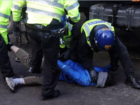 Police arrest a tree campaigner in Sheffield today. Pic: Scott Merrylees