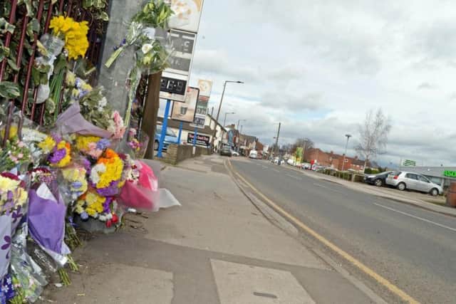 Floral tributes left at the scene of the collision.
