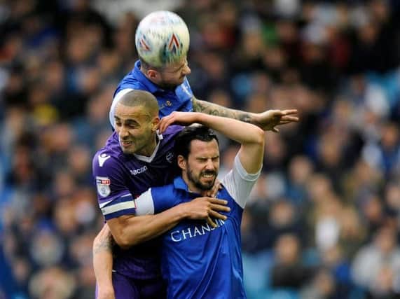Daniel Pudil and George Boyd jump for the ball with Bolton's Darren Pratley