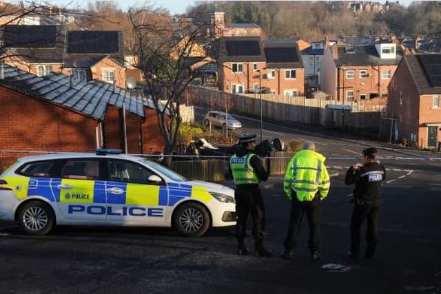 Police officers at the scene of a murder in Burngreave