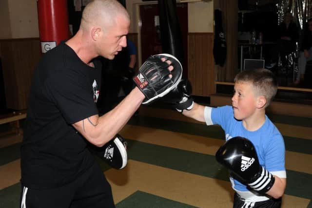 Ex-boxer Reagan Denton works on the pads with David Ward at his gym De Hood. Andrew Roe