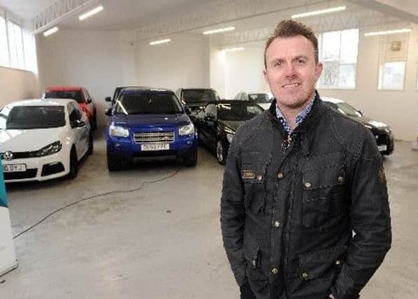 Former Owl Jon Newsome at his Automarques car dealership. Pictures: Andrew Roe
