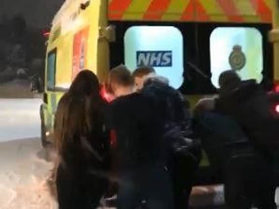 Residents in Broomhill push an ambulance