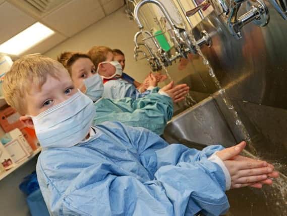 Beaver Noah McNamara, six and his friend Jacob Brashaw, eight, pictured in their scrubs, prepping for theatre.  Pictures: Marie Caley