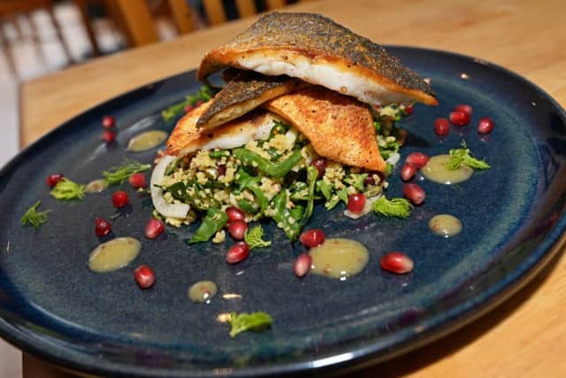 Pan Fried Seabass, served with Cous Cous, Spinach, Fennel, Pomegranate Salad and Honey and Wholegrain Mustard dressing. One of the Main dishes available at Olive Mediterranean restaurant. Picture: Marie Caley NSTE Olive MC 2