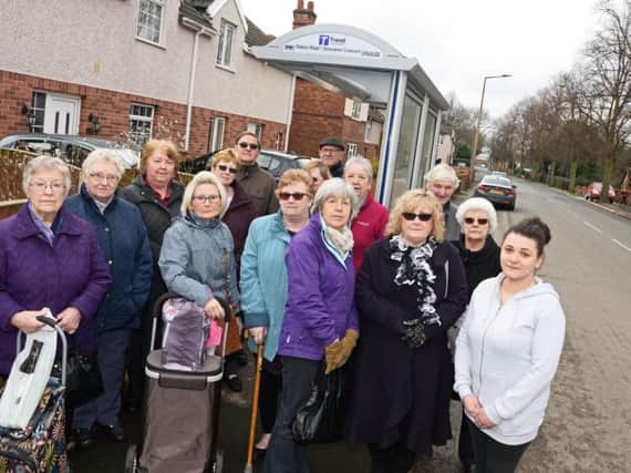 Sasha Bonfield (far right) and other exasperated passengers at the bus stop on Station Road in Arksey (photo: Marie Caley)